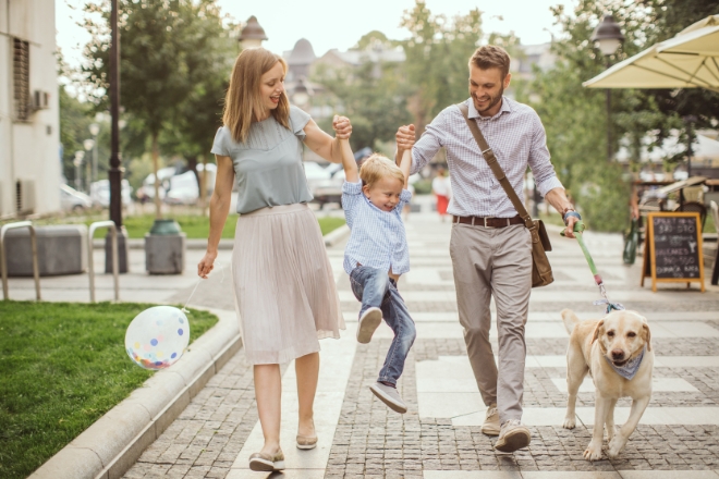 family with dog happily refinanced home loan