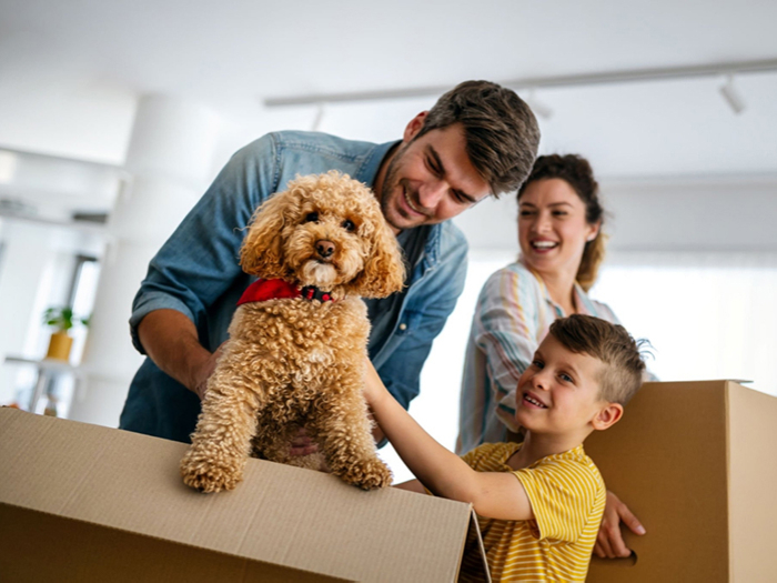 Family with dog moving into their new home after home loan with a mortgage broker