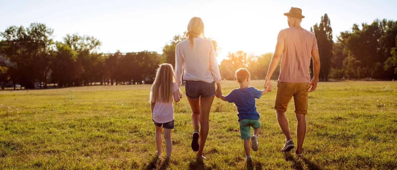 family walking together in sunlight