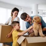 happy family moving house with dog
